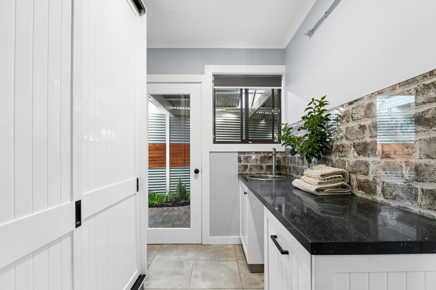 Utility room with cabinetry and an external door
