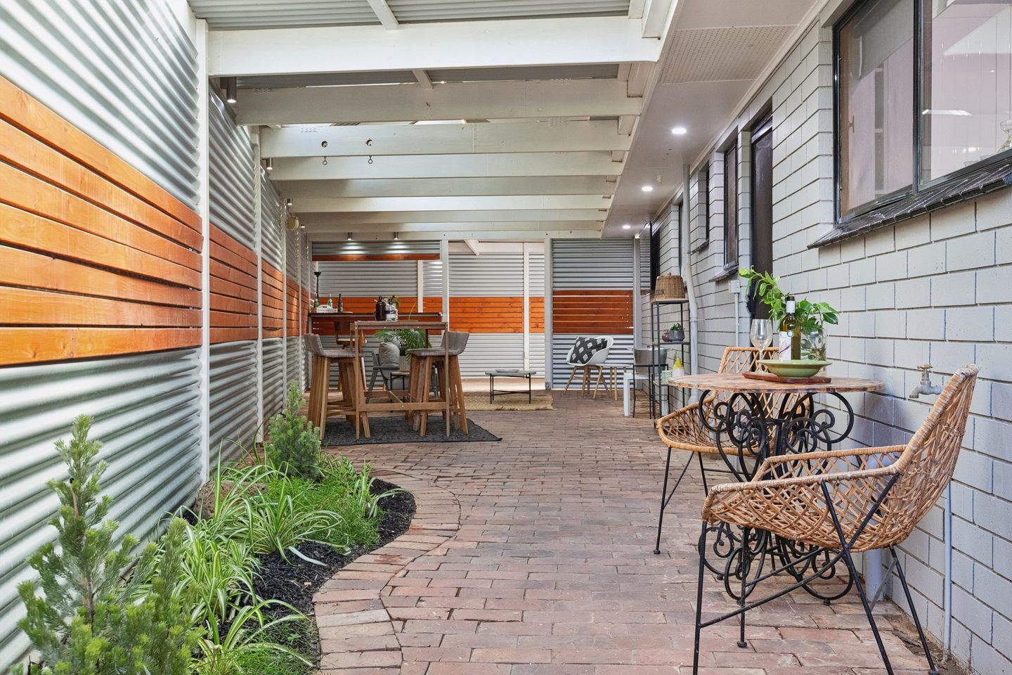 Brick-paved patio with a planted garden edge