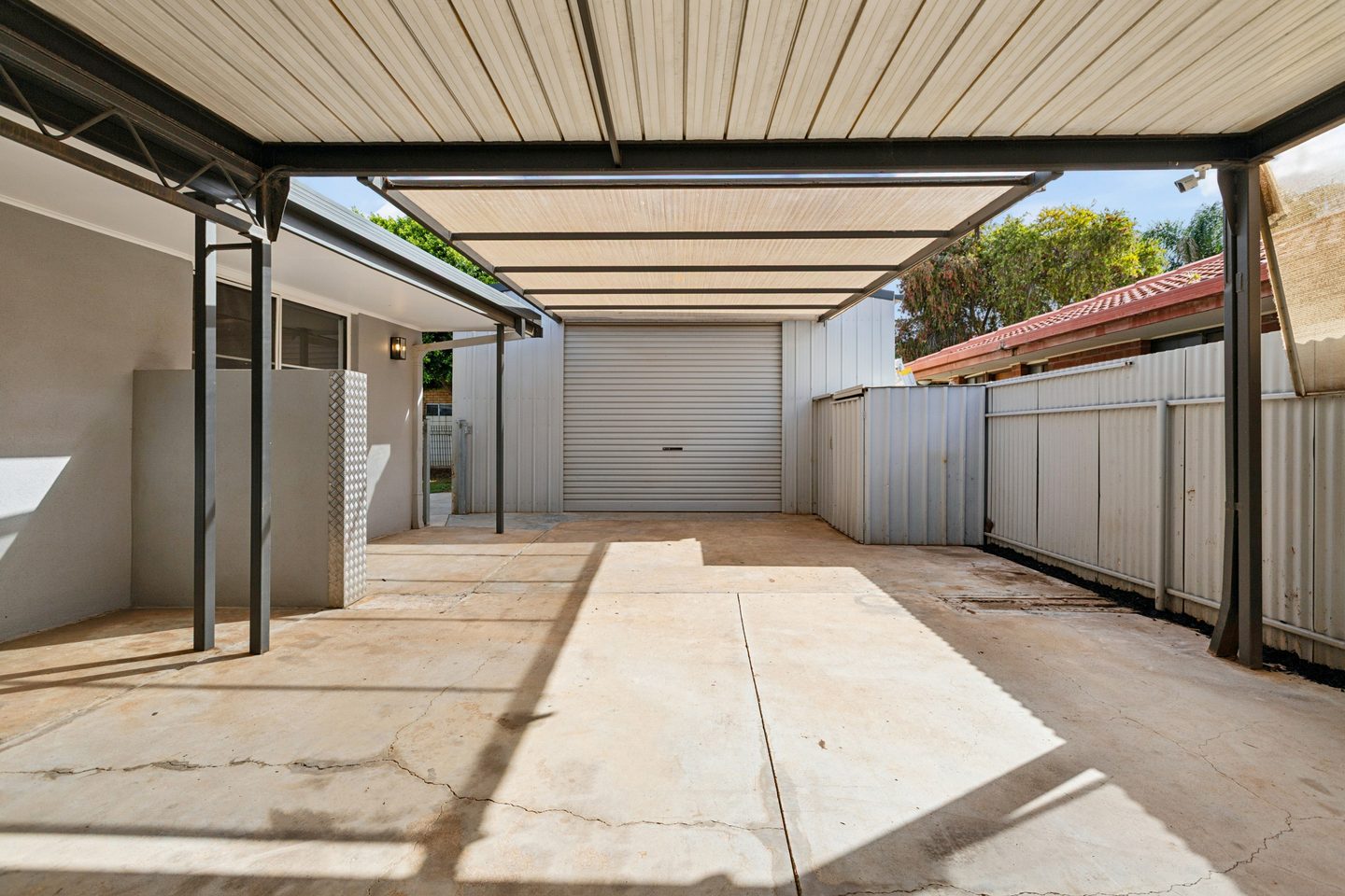 Covered driveway leading towards the shed
