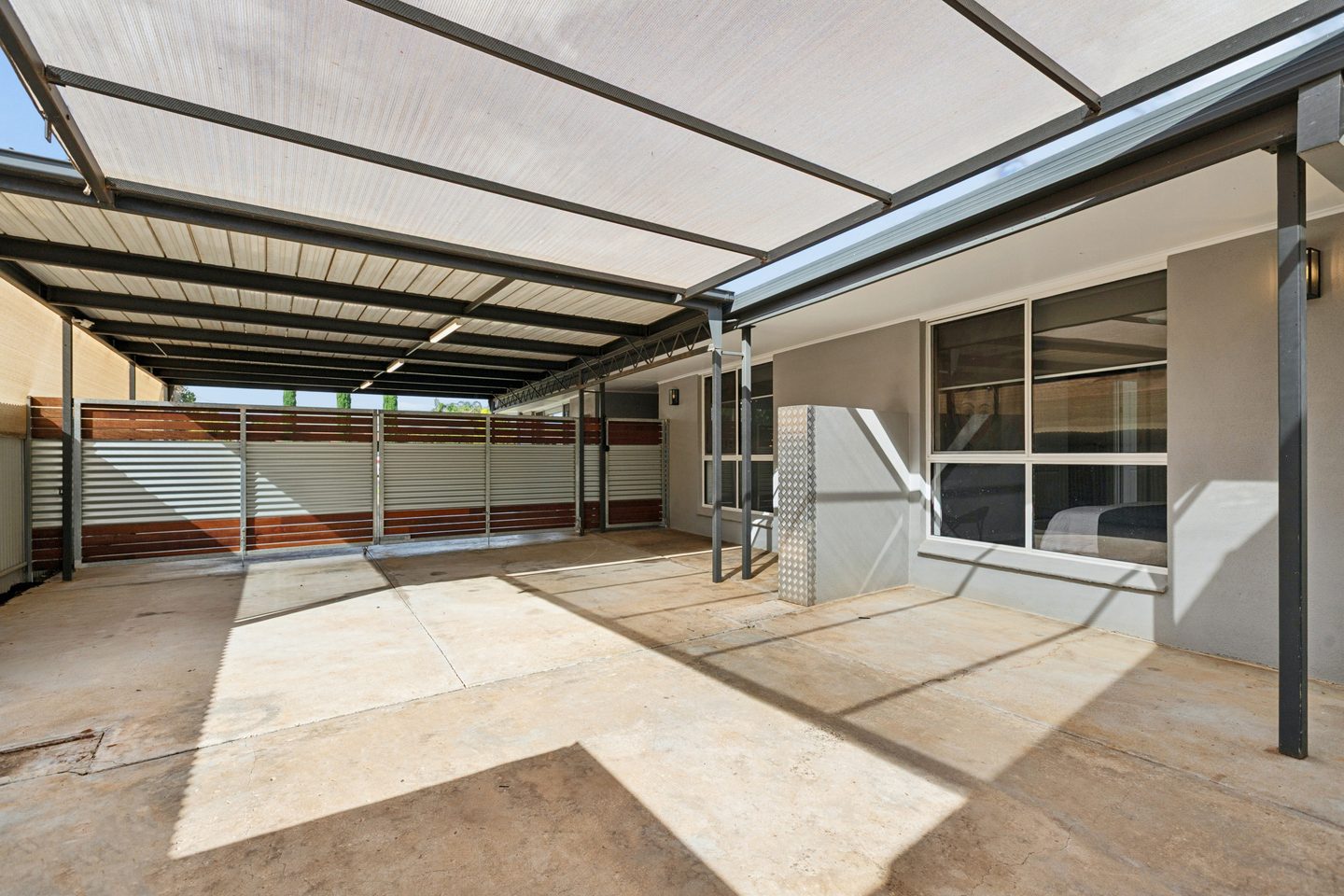 The covered carport beside the home